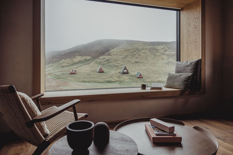 a view from window the highland base hotel in iceland of cabins on a hillside