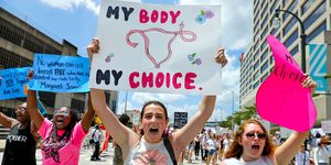 demonstrators hold signs while marching during a protest against georgia's "heartbeat" abortion bill in atlanta, georgia, us, on saturday, may 25, 2019 people gathered to protest the state's recently passed house bill 481, which would ban abortion after a doctor can detect a fetal heartbeat  usually around the sixth week of pregnancy photographer elijah nouvelagebloomberg via getty images