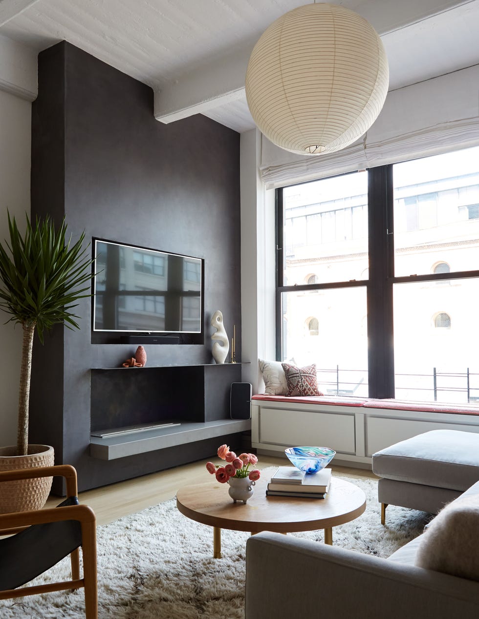 a living room with a fireplace and a large window