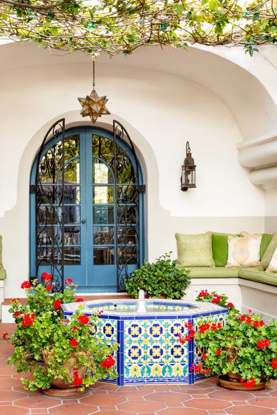 exterior of shames residence doorway, interior design by tom callaway looking over fountain to iron doorway