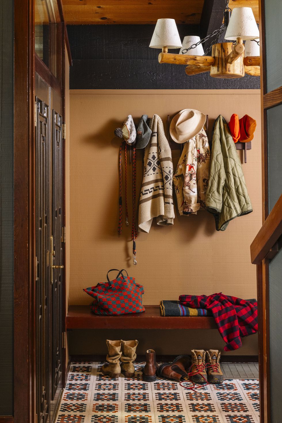 a mudroom with a bench and coat rack