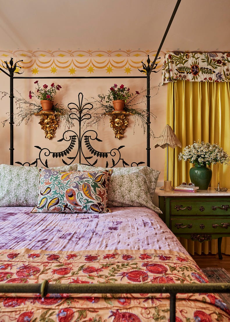 A cozy bedroom featuring a decorative bed colorful textiles and plants
