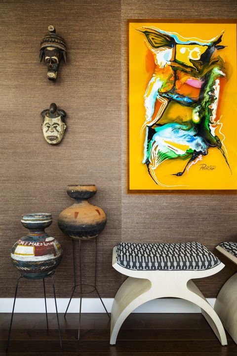 entryway, brown wallpaper, yellow artwork, vases