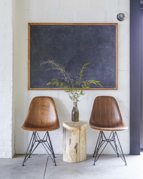 chalk board, wooden chairs, brick wall