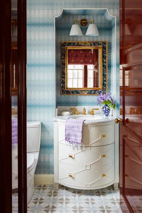 a custom curved vanity with moldings and a merlot lacquered door arroyo red, benjamin moore reflect the movement of the blue wallpaper in this katie ridder powder room