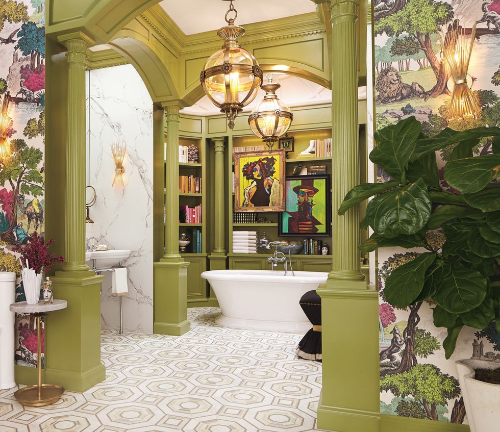 reading room with fully stocked built in shelves and tub side perches for a glass of wine or cup of tea, this otherworldly bathroom by corey damen jenkins is also a library amid the art deco inspired tilework, greek revival columns and arches, and bold artwork animating the bathtub alcove, every stylistic flourish hits the mark floor tiles walker zanger tub dxv wallpaper cole son green paint medieval times, benjamin moore