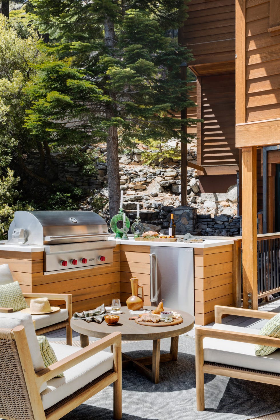 a corner cabinet and undercounter fridge boost the utility of this grilling area by designer jen samson