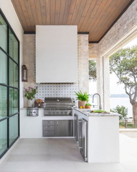 a grill and hood combo lend sophistication to this marie flanagan outdoor kitchen