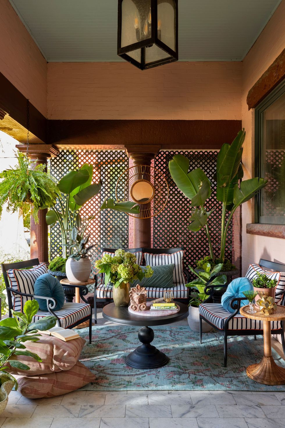 a patio with a table and chairs and plants