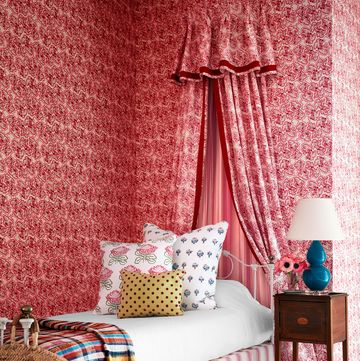 a bed with a pink curtain