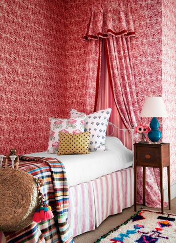 a bed with a pink curtain