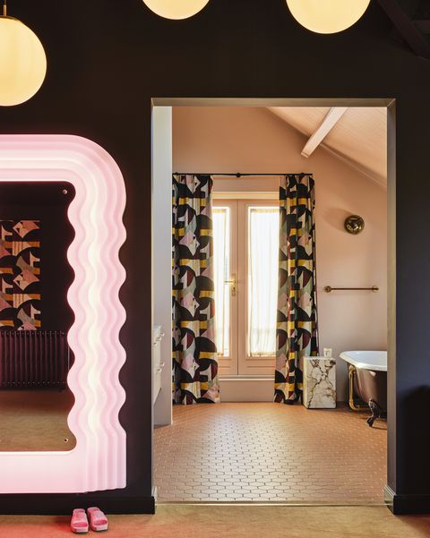 en suite bathroommatching curtains, an open doorway, and a muted caramel color scheme link the two rooms mirror vintage ettore sottsass tiles winckelmans