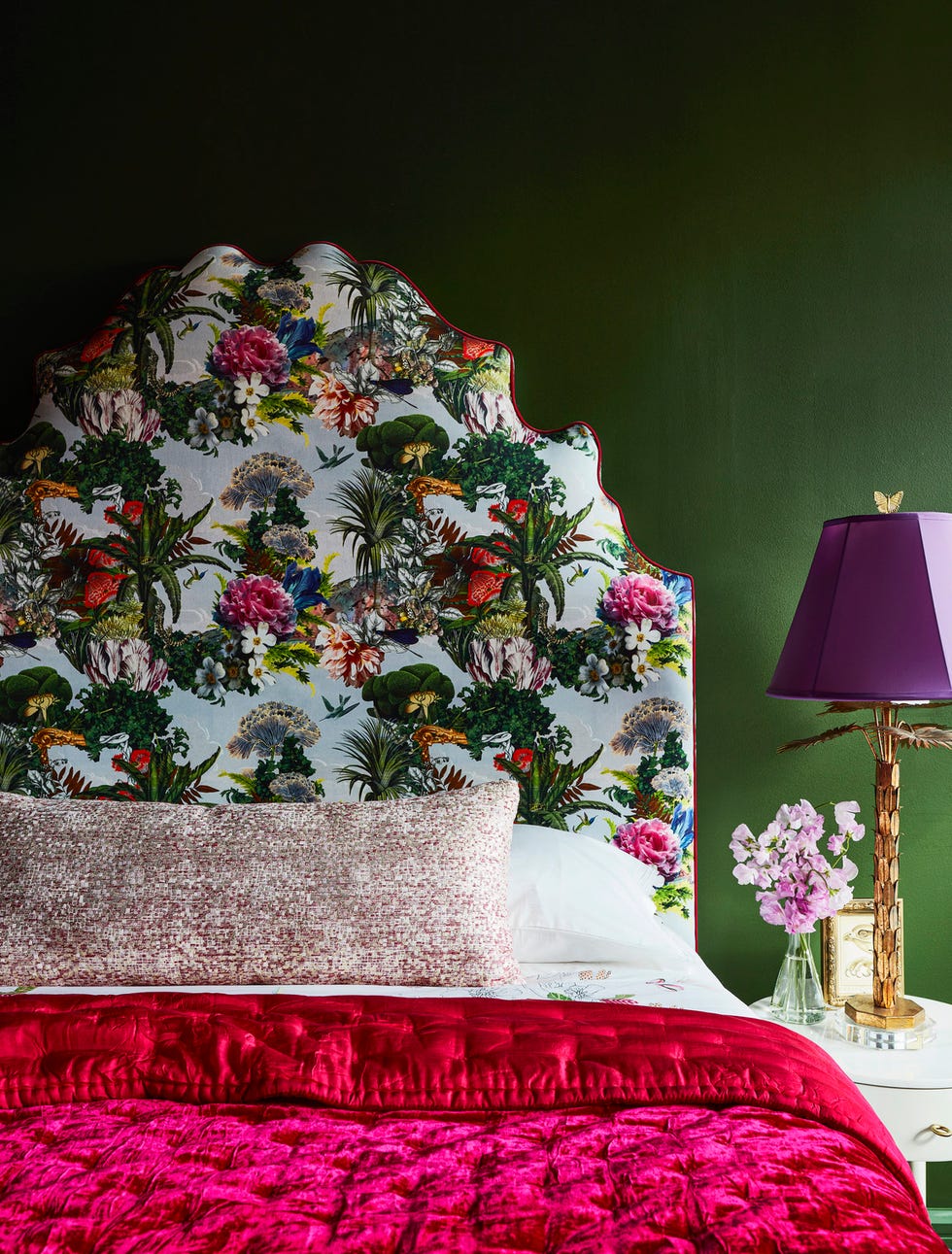 main bedroom. manhattan apartment by designer courtney mcleod/right meets left interior design. headboard: o. henry house, in jardin des reves prisme by christian lacroix fabric, osborne  little. paint: colonial verdigris, benjamin moore. bolster fabric: raspberry parade, makrosha. blanket: hunt slonem. lamp: wildwood with a broome lampshades shade.