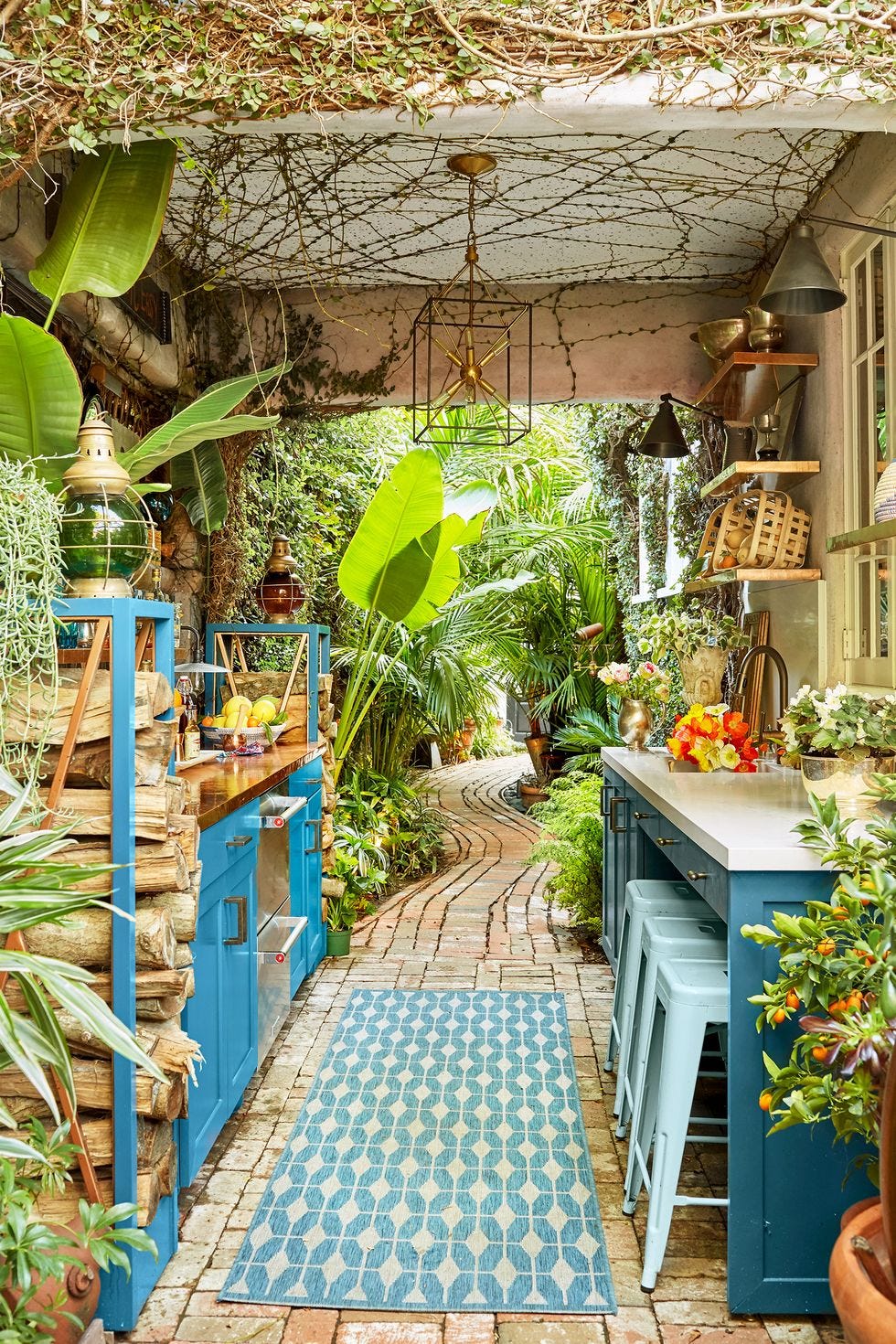 a small galley outdoor kitchen with bright blue cabinetry