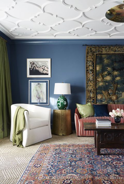 sitting room, blue painted wall, red couch, textured rug and carpet