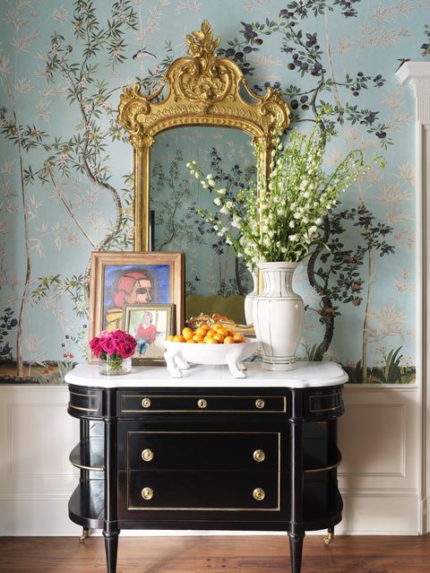 entry way, floral wallpaper, black side table