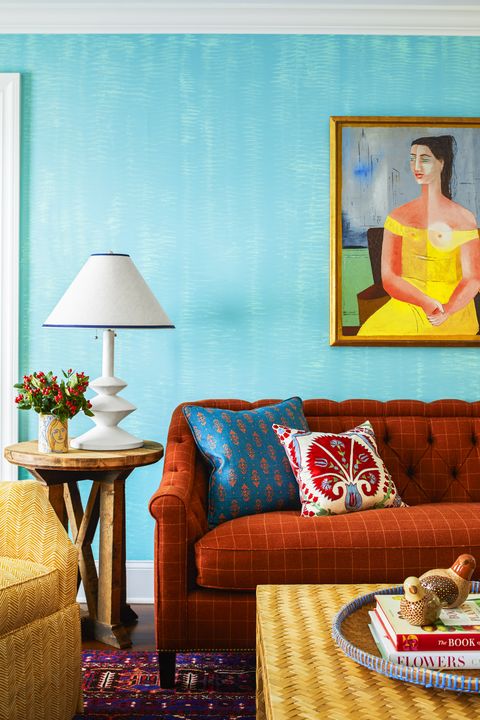 blue wallpaper, orange couch, artwork