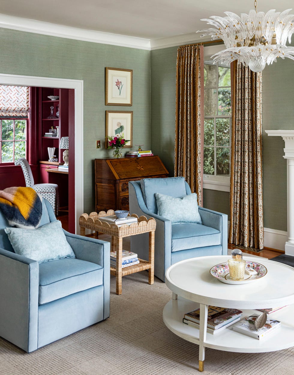 a living room with a blue chair and a table