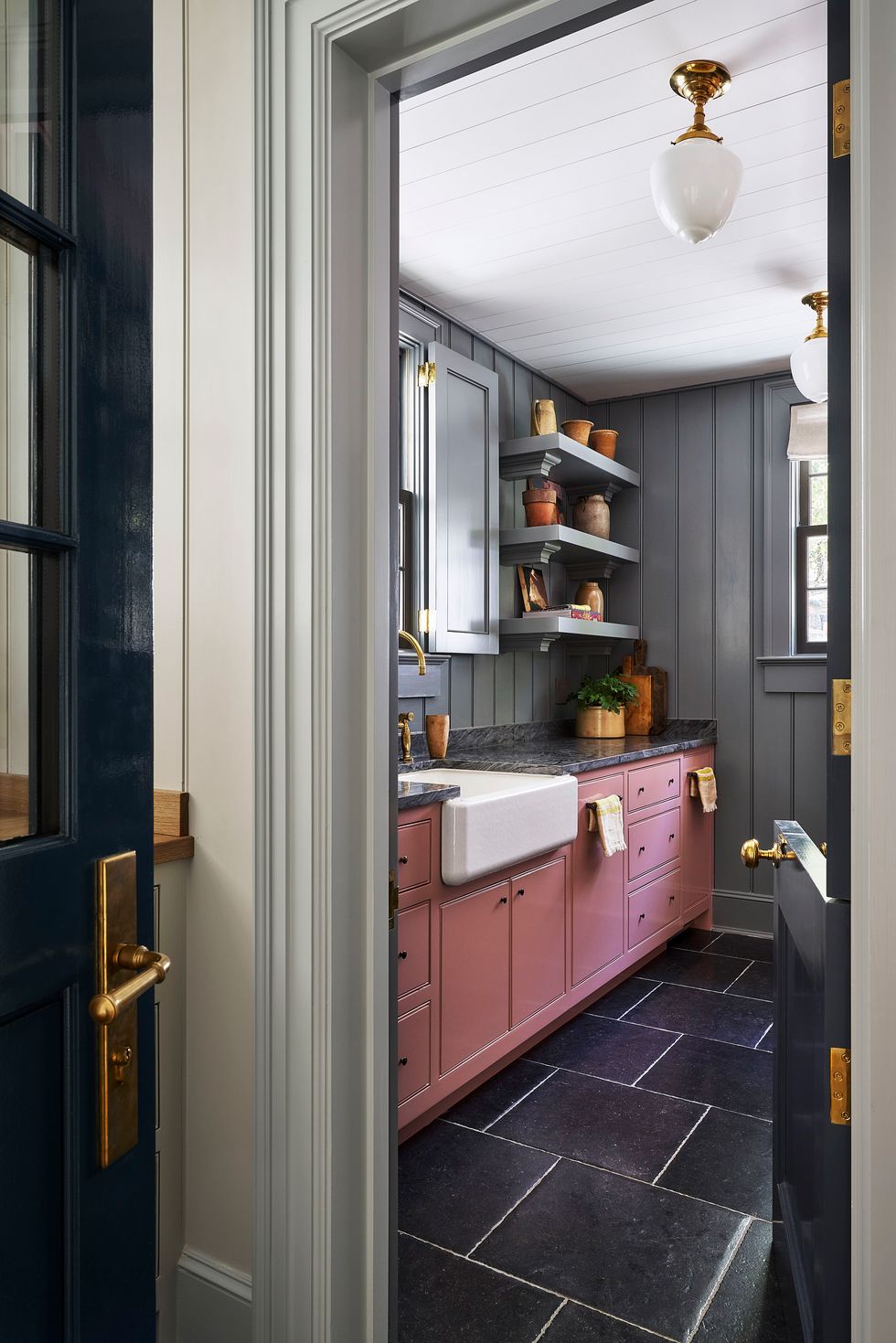 a kitchen with pink cabinets