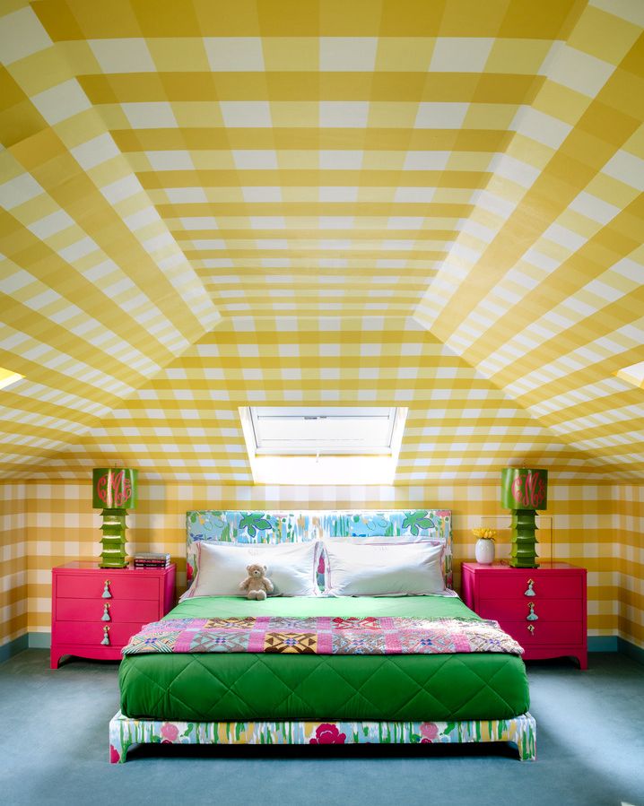 a bed with a colorful wallpaper