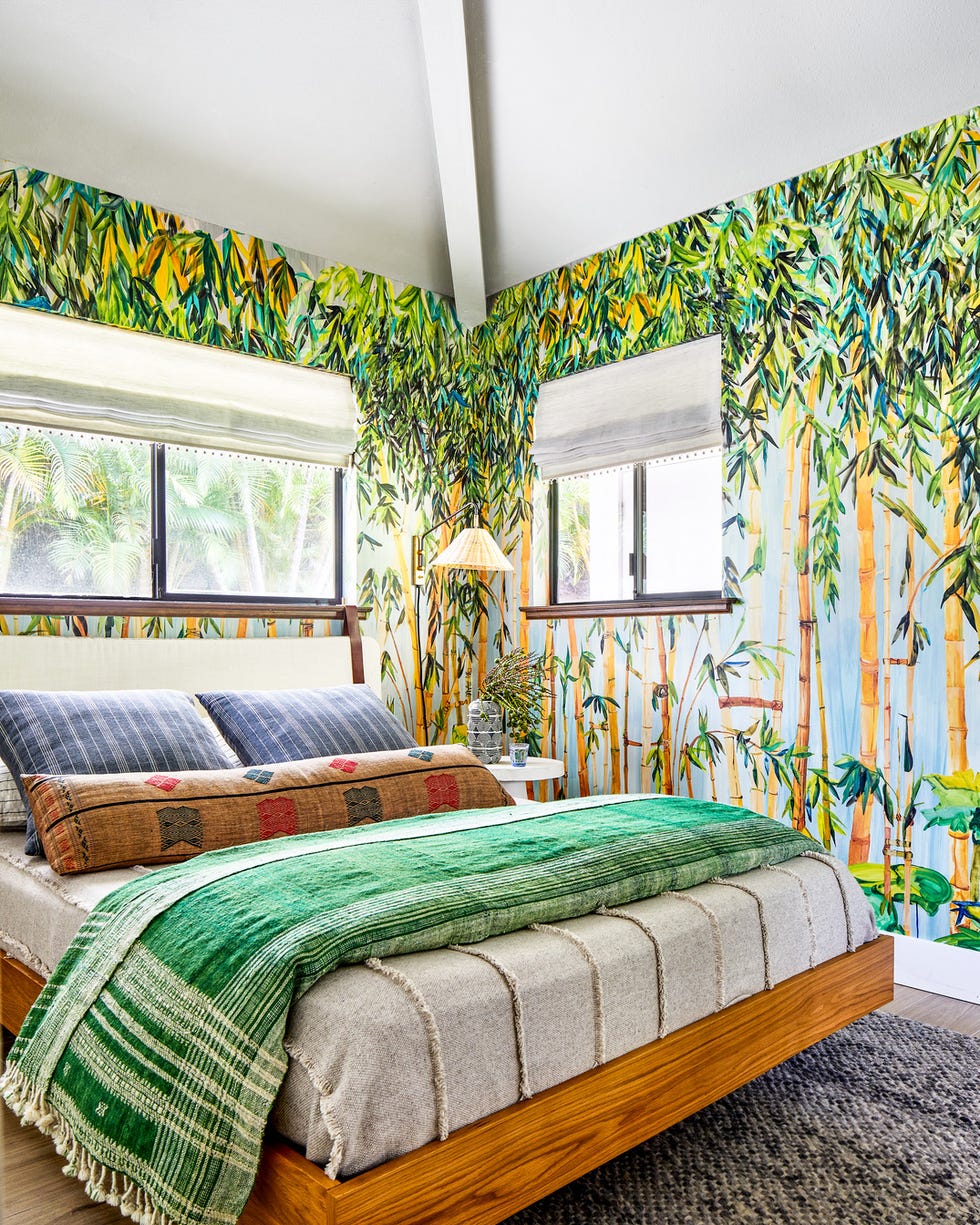 vacation home in maui, hawaii designed by breeze giannasio interiors cottage bedroom a jungle print voutsa mural sets a very hawaiian scene headboard norwegian wood, etsy bed frame article pillows st frank blue, chairish bolsters blankets shoppe by amber interiors cream and pom pom at home green shades the shade store side table crate barrel rug jaipur living