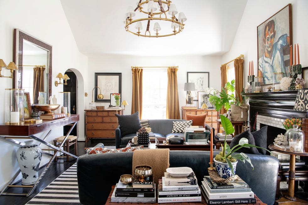 1930's cottage designed by burkle creative. living room. chandelier, console, and sconce: ralph lauren home. paint: chantilly lace, benjamin moore. sofas: arteriors. coffee table: vintage. sketches: by burkles grandmother.