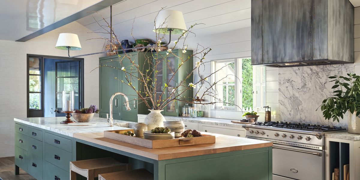 interior designer jeffrey alan marks' american colonial revival home near butterfly beach in montecito, california kitchen cabinetry and knobs plain english paint strong white, farrow  ball walls and white cabinets dripping tap, plain english green cabinets pendant the urban electric co with custom shades faucet waterworks counter stools custom, jam for palecek wood jam for a rudin in rose tarlow range lacanche range hood custom zinc, mainz builders leather pulls custom, richard wrightman