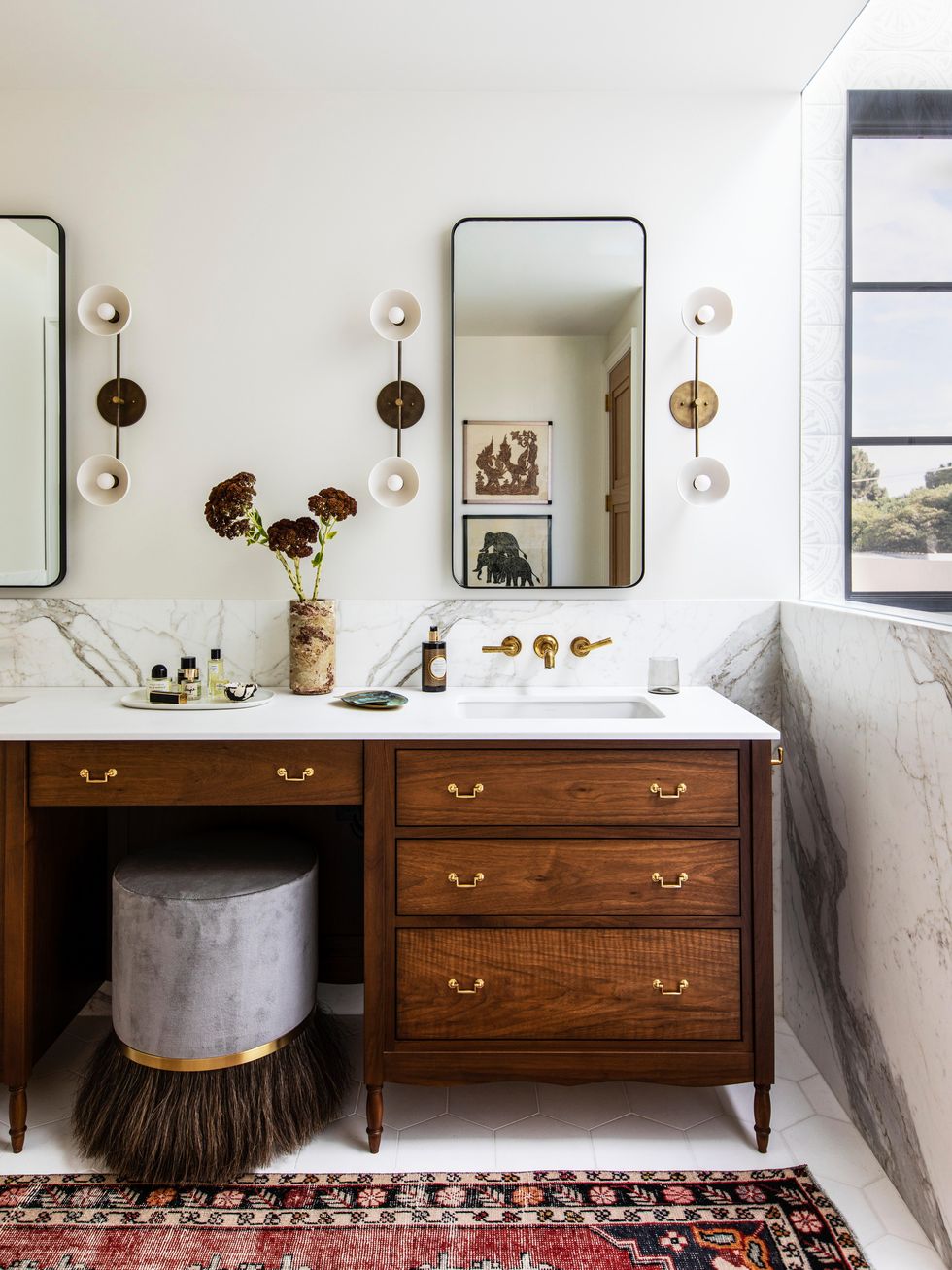 bathroom with marble and gold fixtures