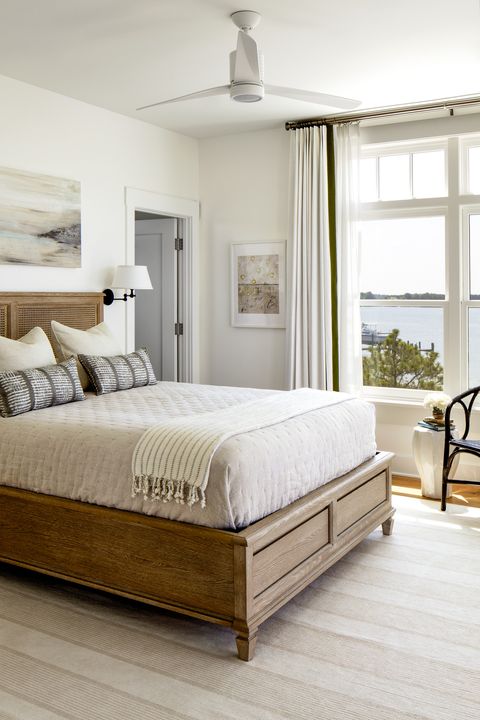 guest room custom pillows wrapped in kravet fabric call to the reeds swaying outside bed universal furniture discontinued table and chair domain by laura hodges studio rug annie selke sconce circa lighting ceiling fan minka aire paint simply white, benjamin moore