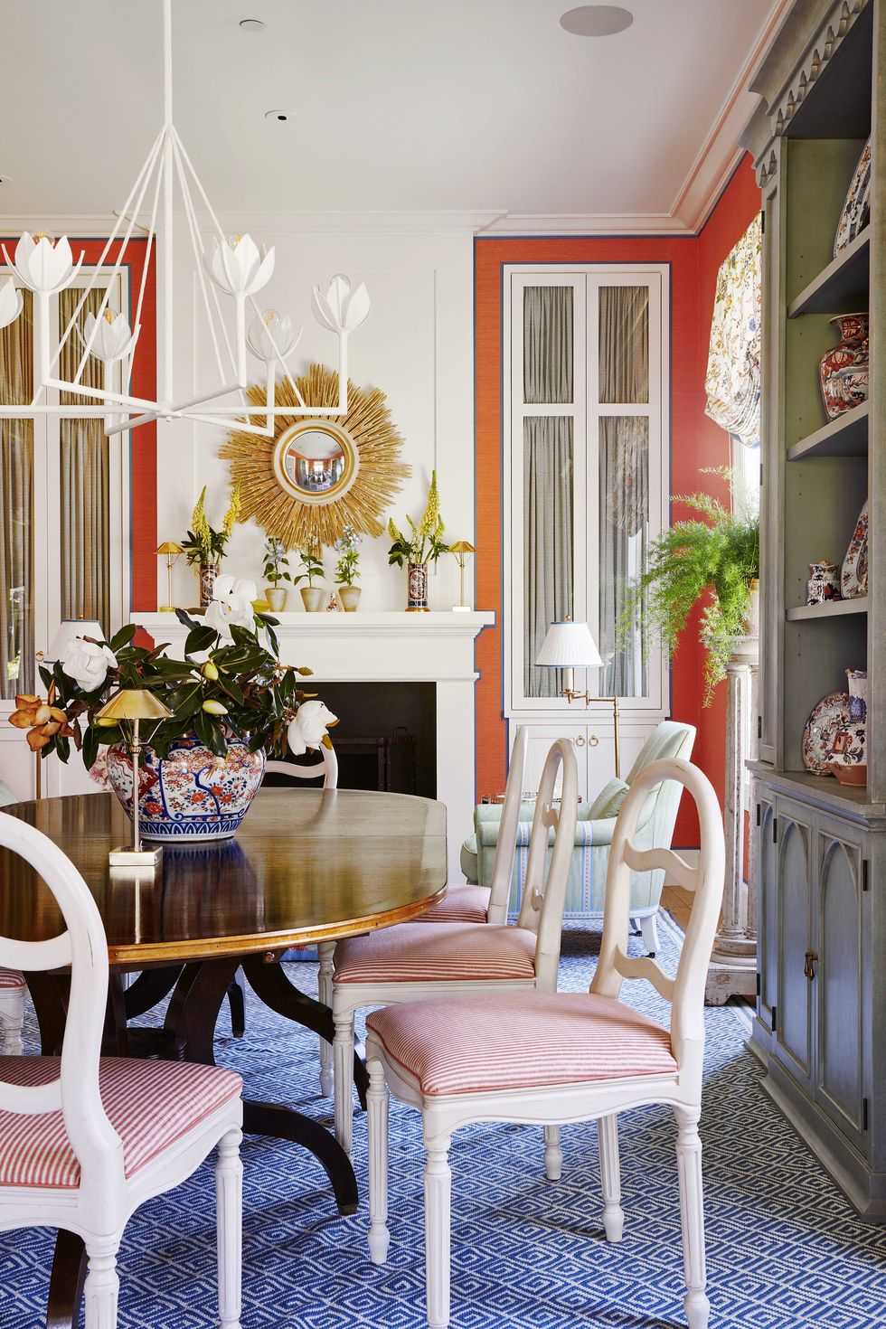 dining table, white and red chairs, orange wallpaper