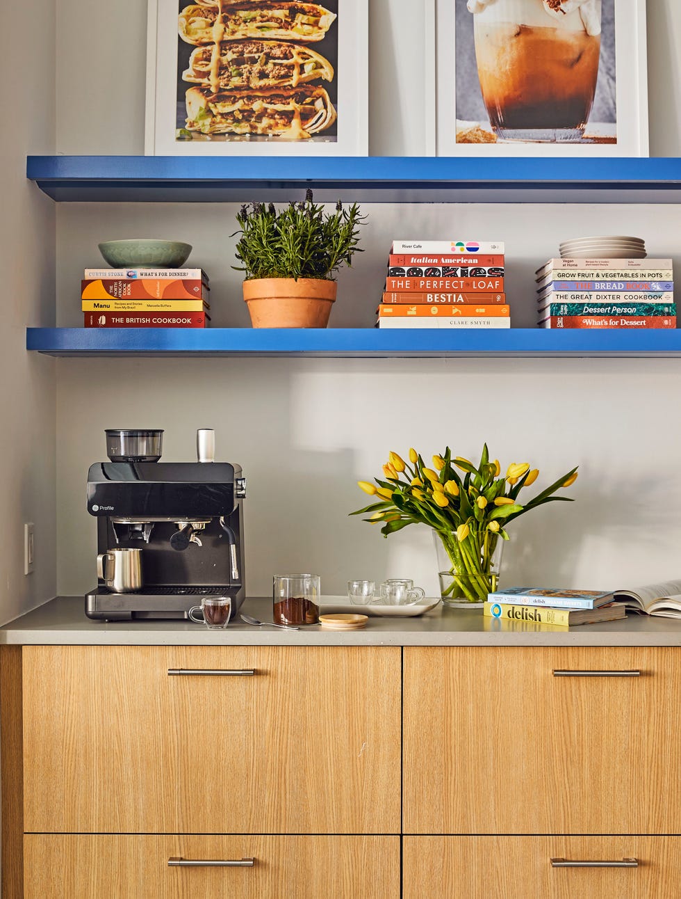 coffee bar with an espresso machine and cookbooks on the shelves