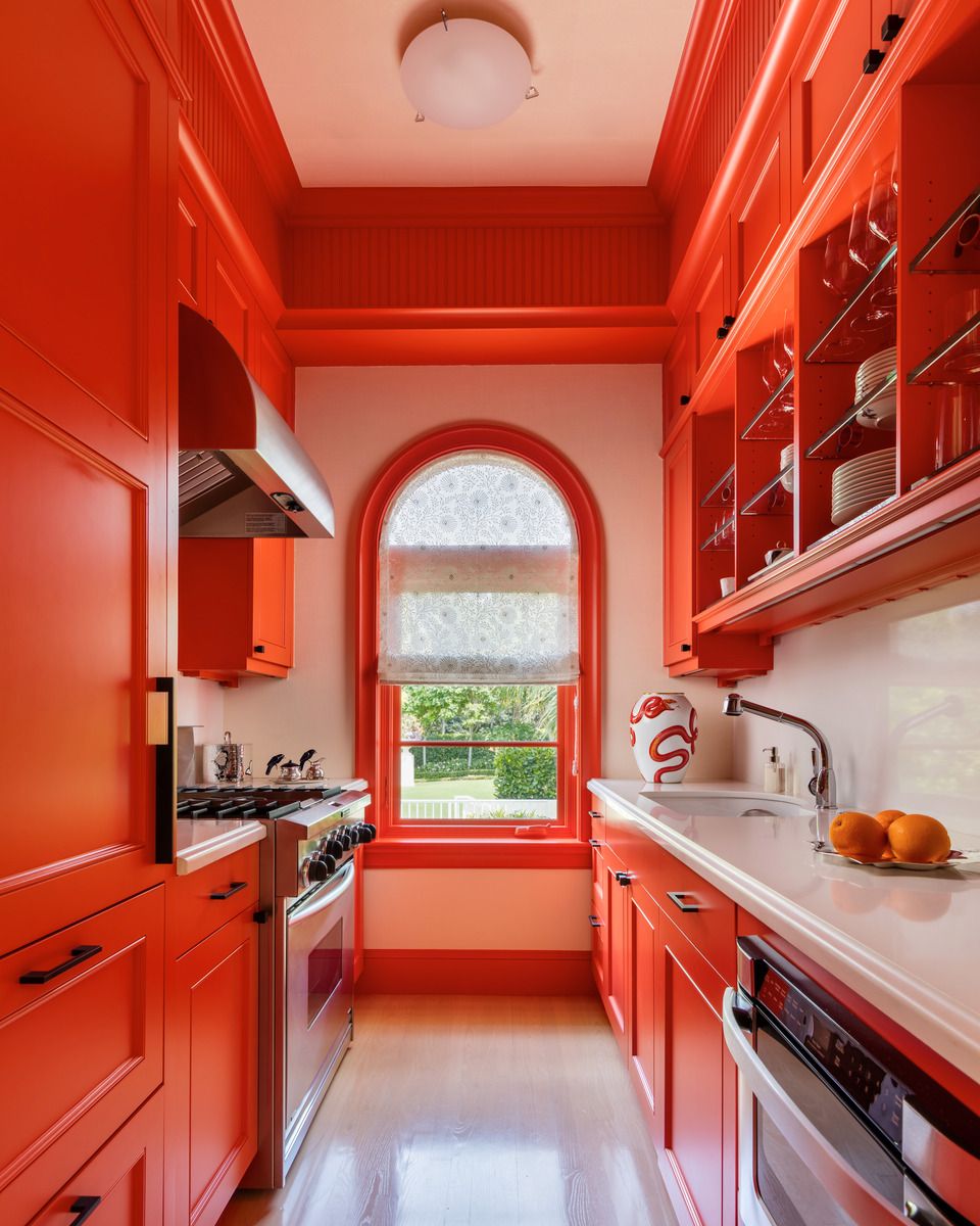 to make a florida kitchen radiate cheer, even on overcast days, designer matthew boland opted for cabinetry and trim in energetic orange by sherwin williams