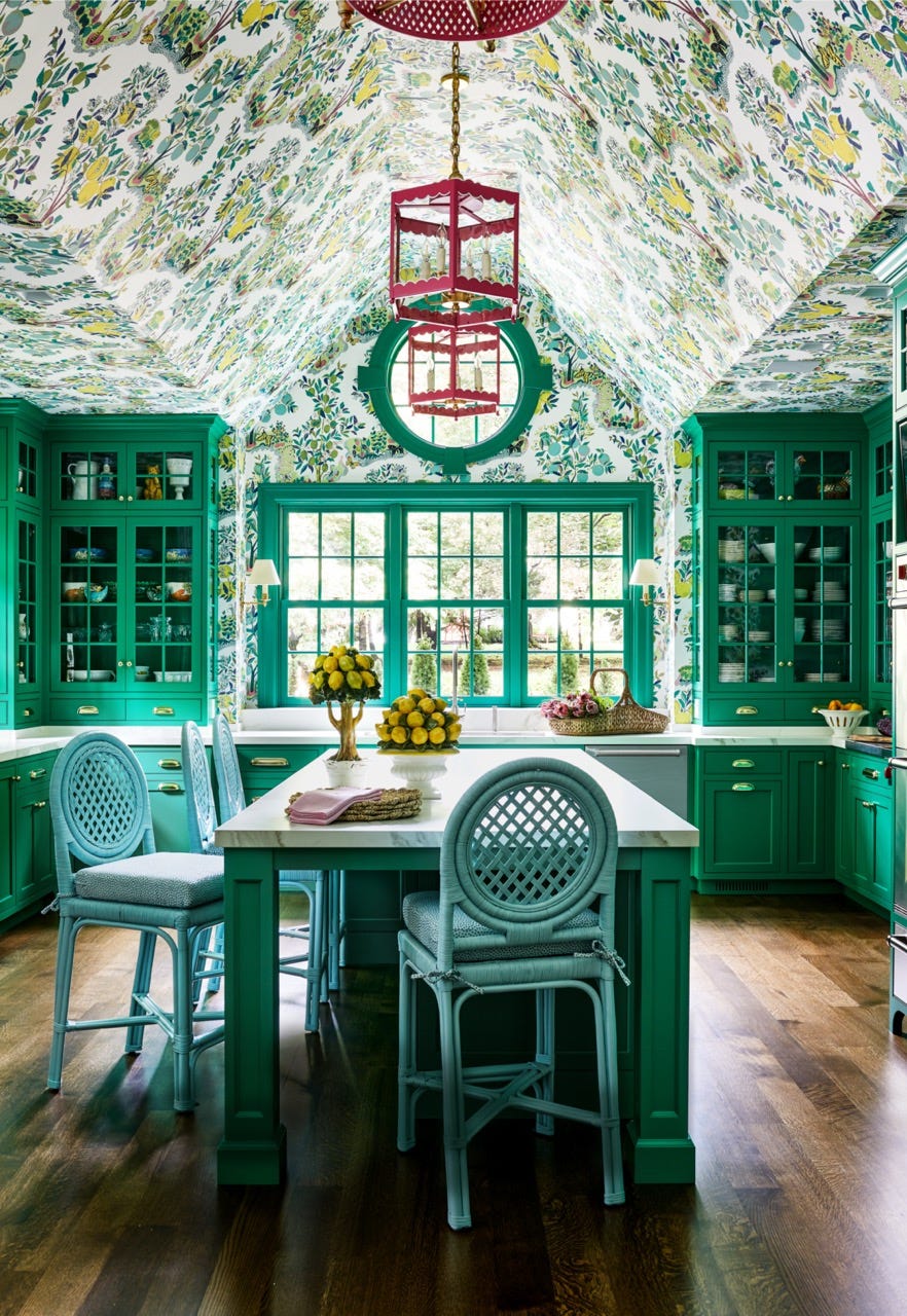 Designer Molly Singer designed this kitchen's custom green cabinets, which match the Schumacher wallpaper.