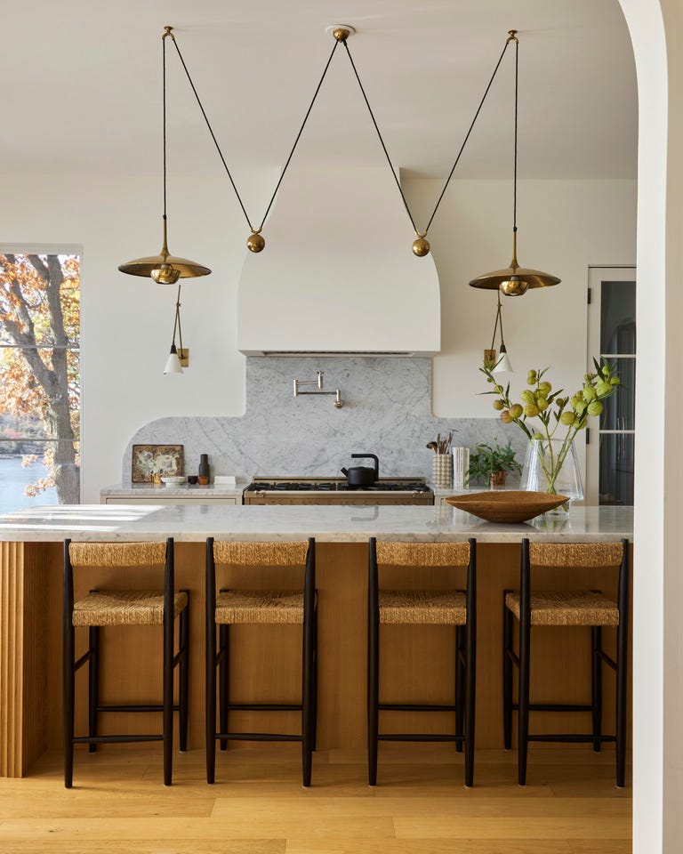 tired of the same old subway tile enter the era of custom cut stone backsplashes these tailored designs\, like the carved marble in this ontario\, canada\, kitchen by sam sacks design\, make a statement