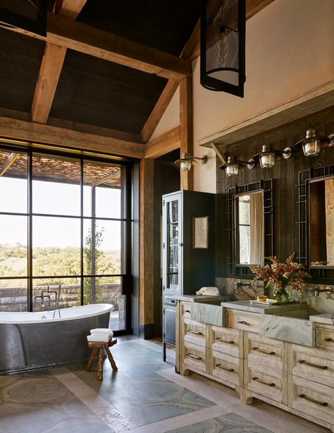 bathroom with pewter tub, double sinks, sliding doors leading outside