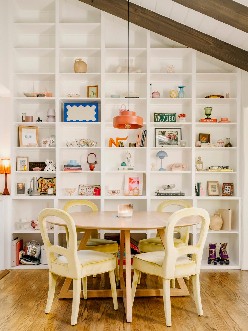 a white table with chairs and shelves