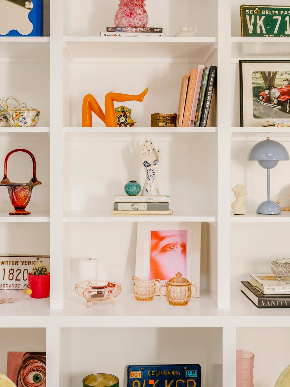 a white shelving unit with various objects on it