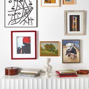 gallery wall featuring various styles of art and frames