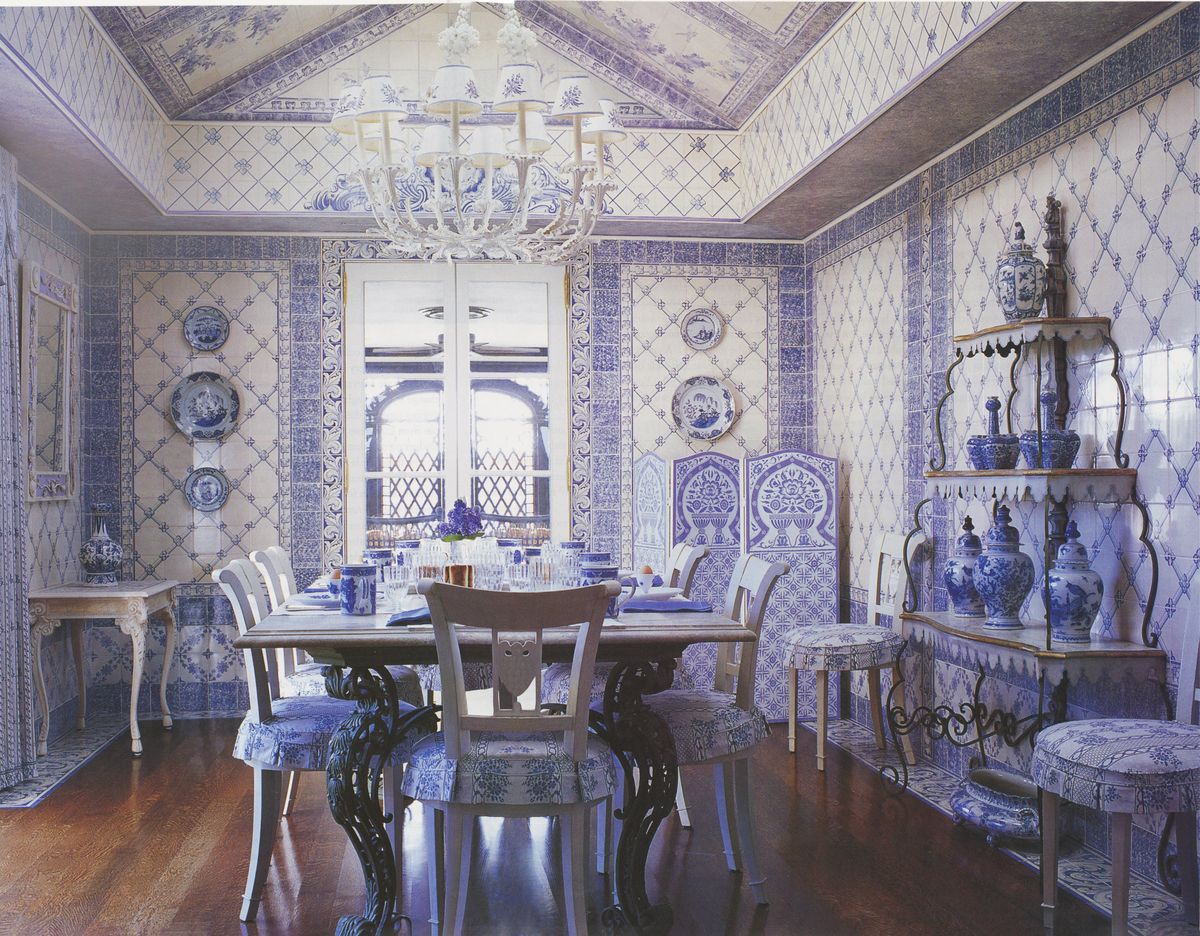 dining room, blue and white wall covering, vases, dining table set up with blue and white fine china and cutlery