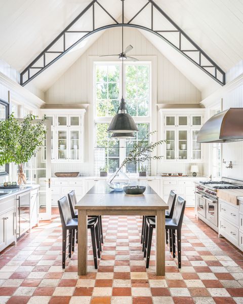 kitchen designer victoria hagan restored some of the white painted beams to their original iron color and painted parts of the existing tumbled marble floor range and hood wolf pendants 360 volt table custom, in oak and petit granit counter stools asher israelow in spinneybeck leather fan circa lighting
