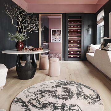 wine bar and tasting room, circular table, wall sofa, circular stool seats, pink ceiling, bark green painted walls
