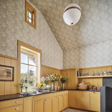 laundry room, yellow cabinets, flowers, wallpaper