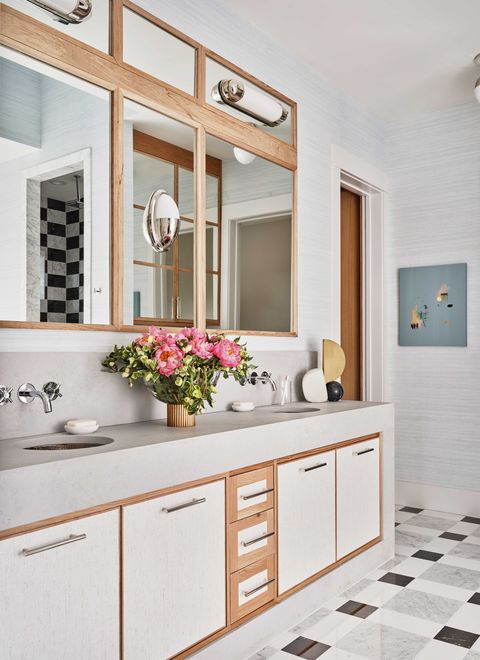 white bathroom vanity, stainless steel handles, mirror, flowers