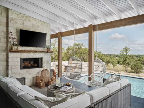 outdoor patio, wooden beams, outdoor tv, outdoor white and gray furniture, white hanging chairs