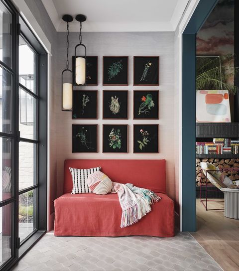 entryway, red couch, black floral wall art
