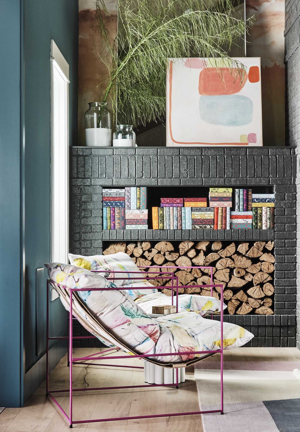 sitting area, wood stack, fireplace, colorful lounge chairs