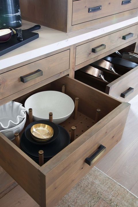 drawers with dinnerware and pans and pots