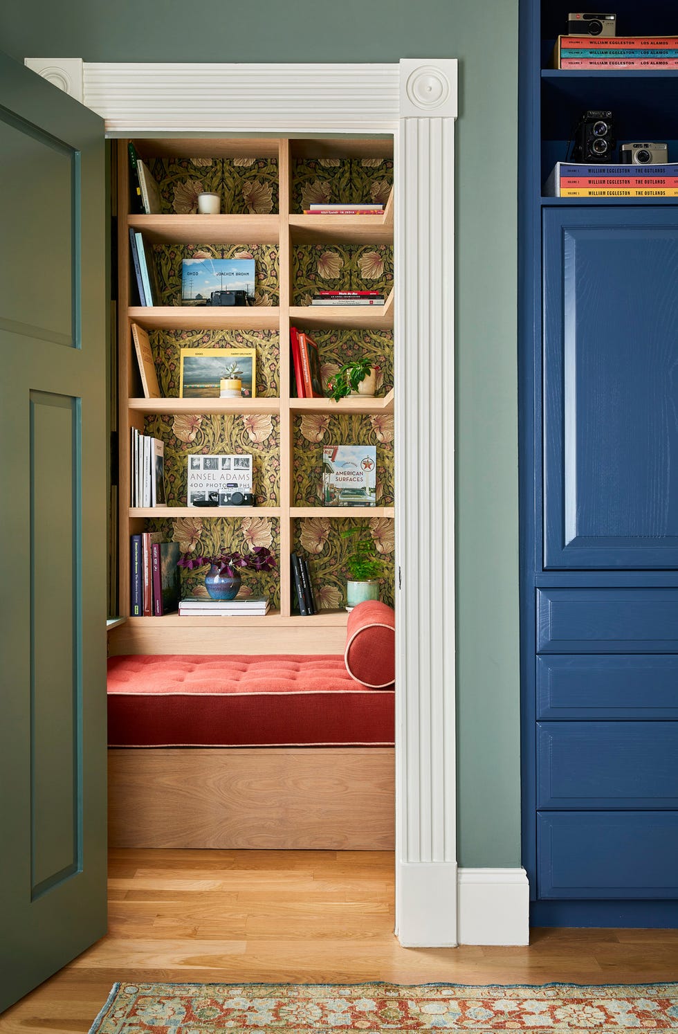 period morris  co. wallpaper offsets custom white oak bookshelves.