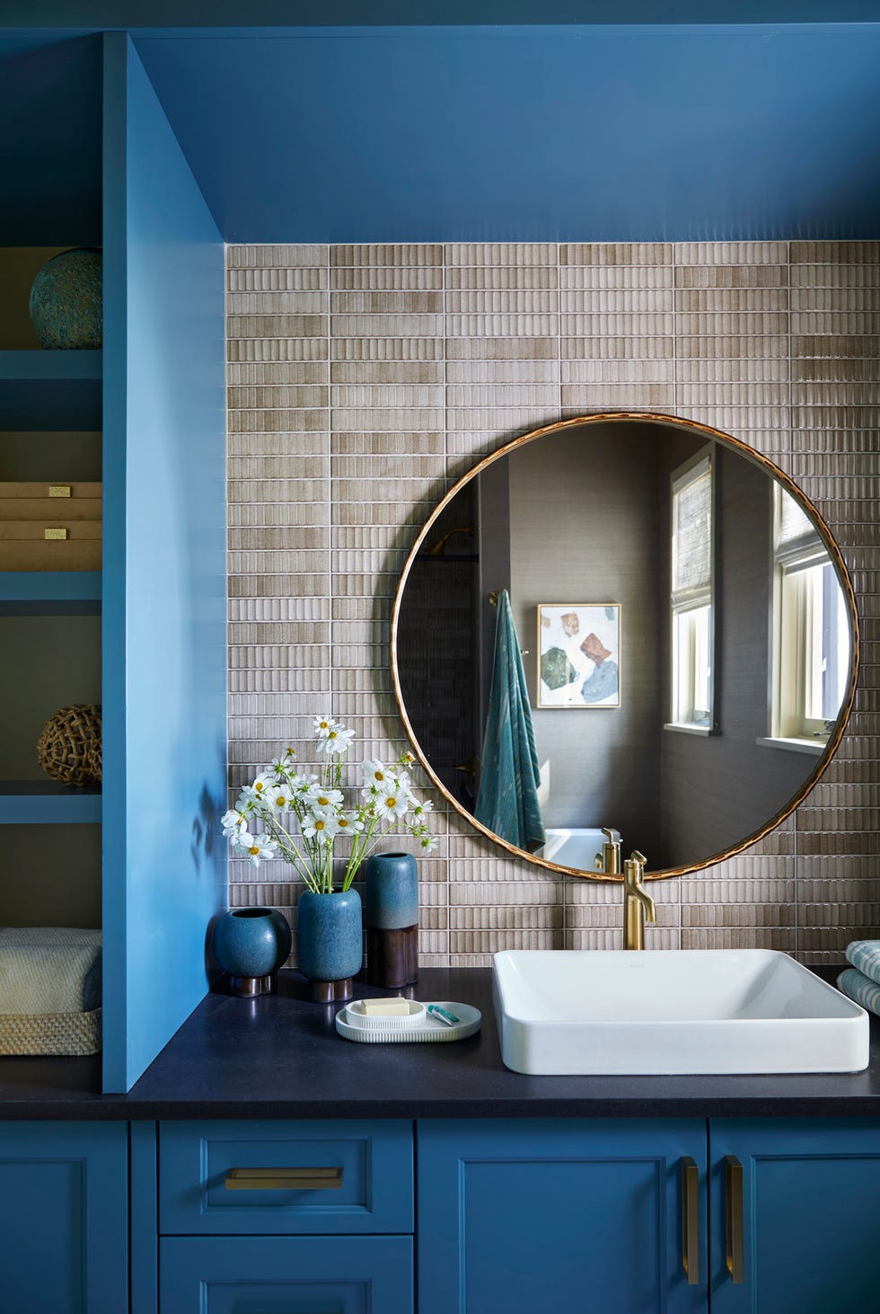 Modern bathroom interior featuring a round mirror sink and stylish decor