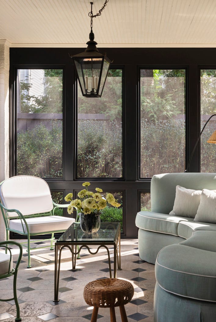 hold the line: elegant design\, neutral color palette. chicago home designed by wendy labrum with michael abraham architecture. inspiration: english country estate with a contemporary twist. porch a once “dark and dank” screened in porch now boasts an inviting curvy sofa in perennials fabric. pendant: mclean lighting works. lamp: atelier vime. table: blend interiors. blue sofa. hold the line: elegant design\, neutral color palette. chicago home designed by wendy labrum with michael abraham architecture. inspiration: english country estate with a contemporary twist. porch a once “dark and dank” screened in porch now boasts an inviting curvy sofa in perennials fabric. pendant: mclean lighting works. lamp: atelier vime. table: blend interiors. blue sofa.